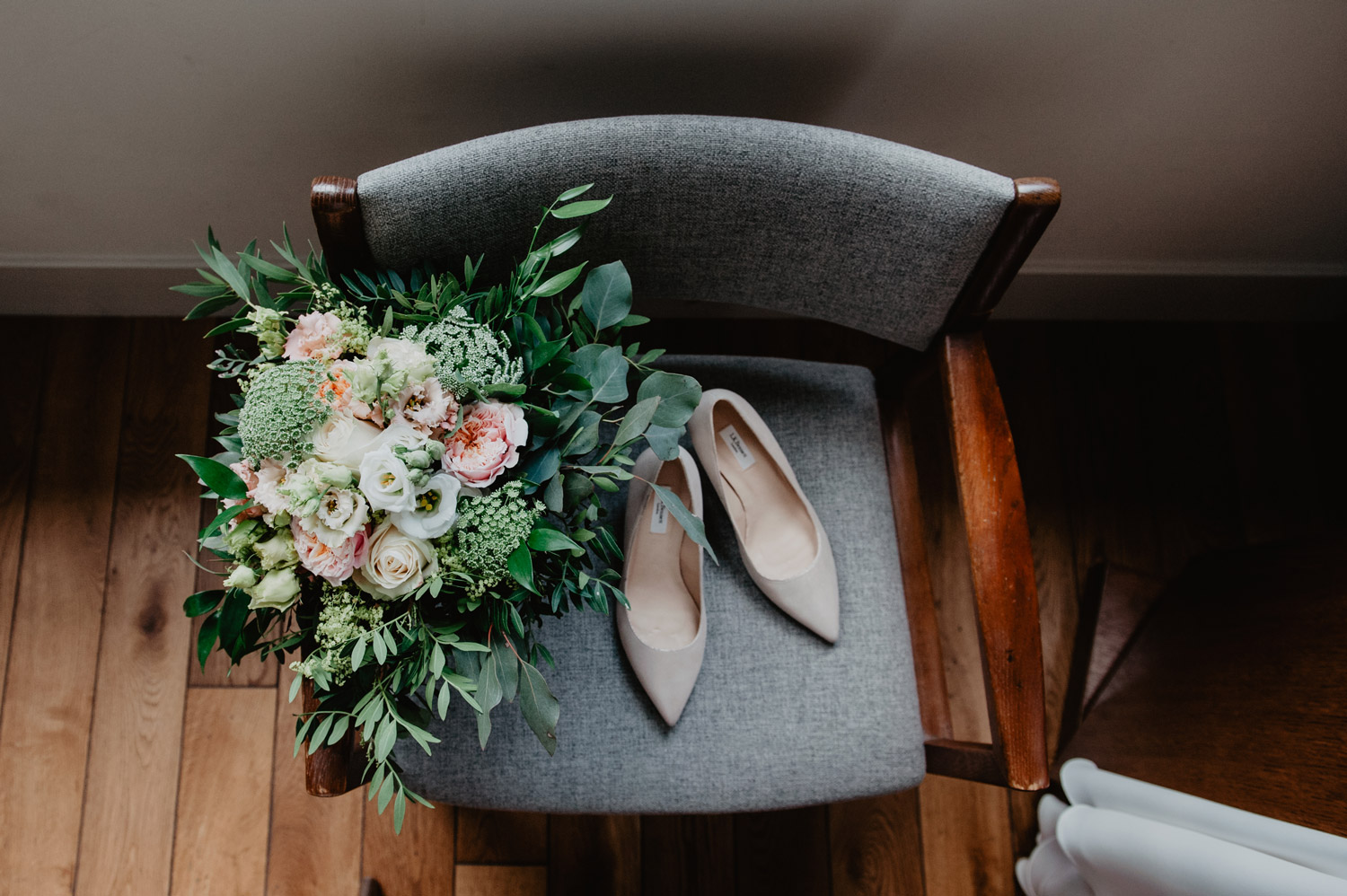 london town hall hotel wedding bouquet with ferns on midcentury modern chair