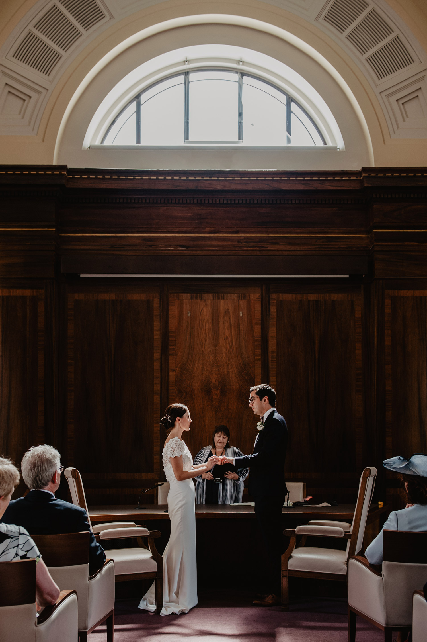 stoke newington town hall wedding bride groom in sunlight exchanging rings