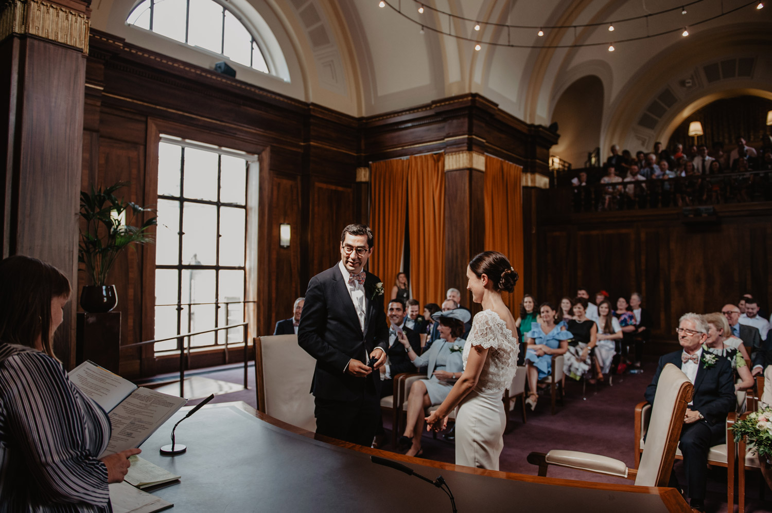 stoke newington town hall wedding bride groom in sunlight exchanging rings