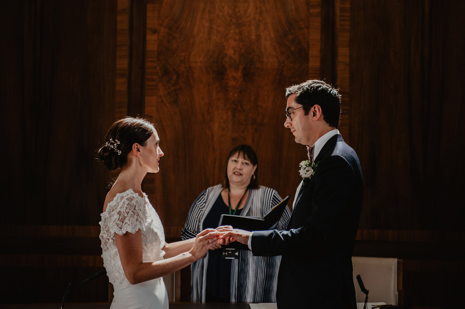 stoke newington town hall wedding bride groom in sunlight exchanging rings