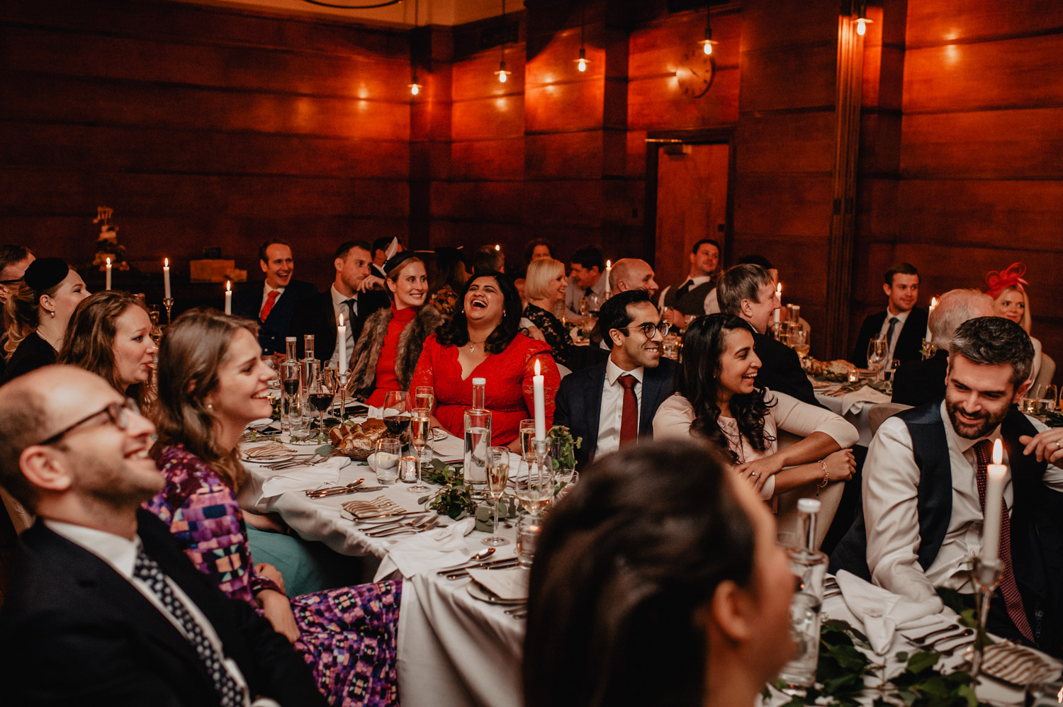 wedding guests laughing during speeches