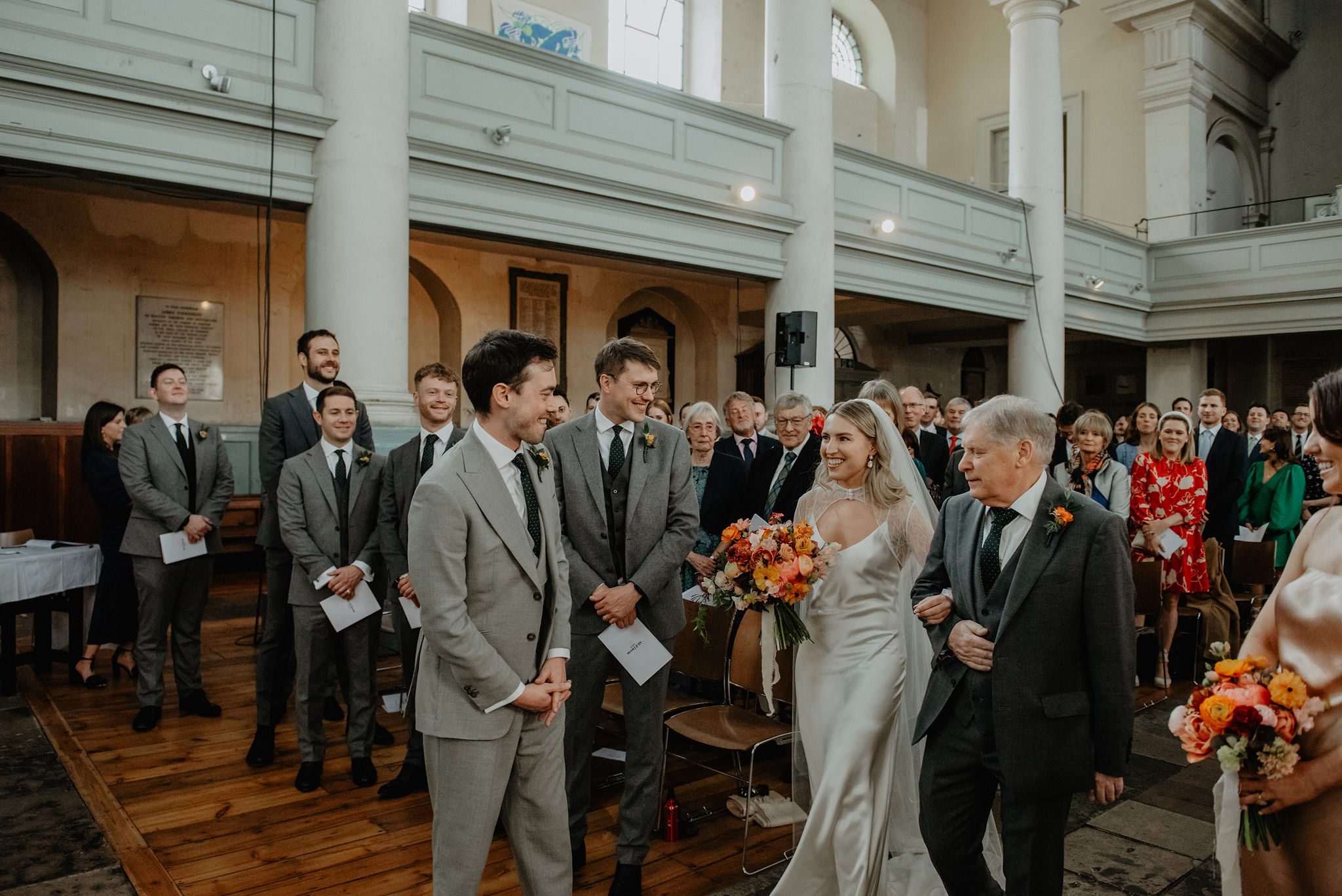 bride walking down the aisle at shoreditch church during wedding