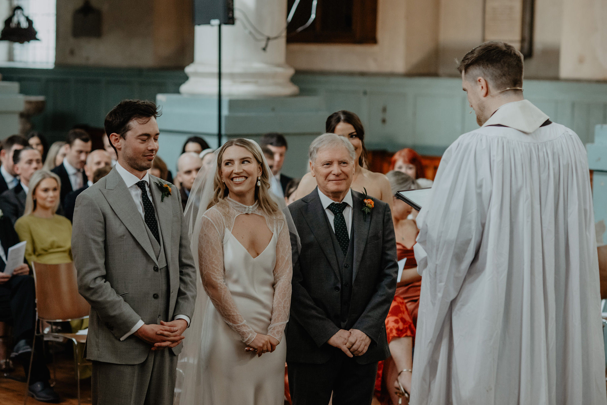 bride smiling at groom during fine art wedding by anne schwarz photography at shoreditch church st leonards hackney