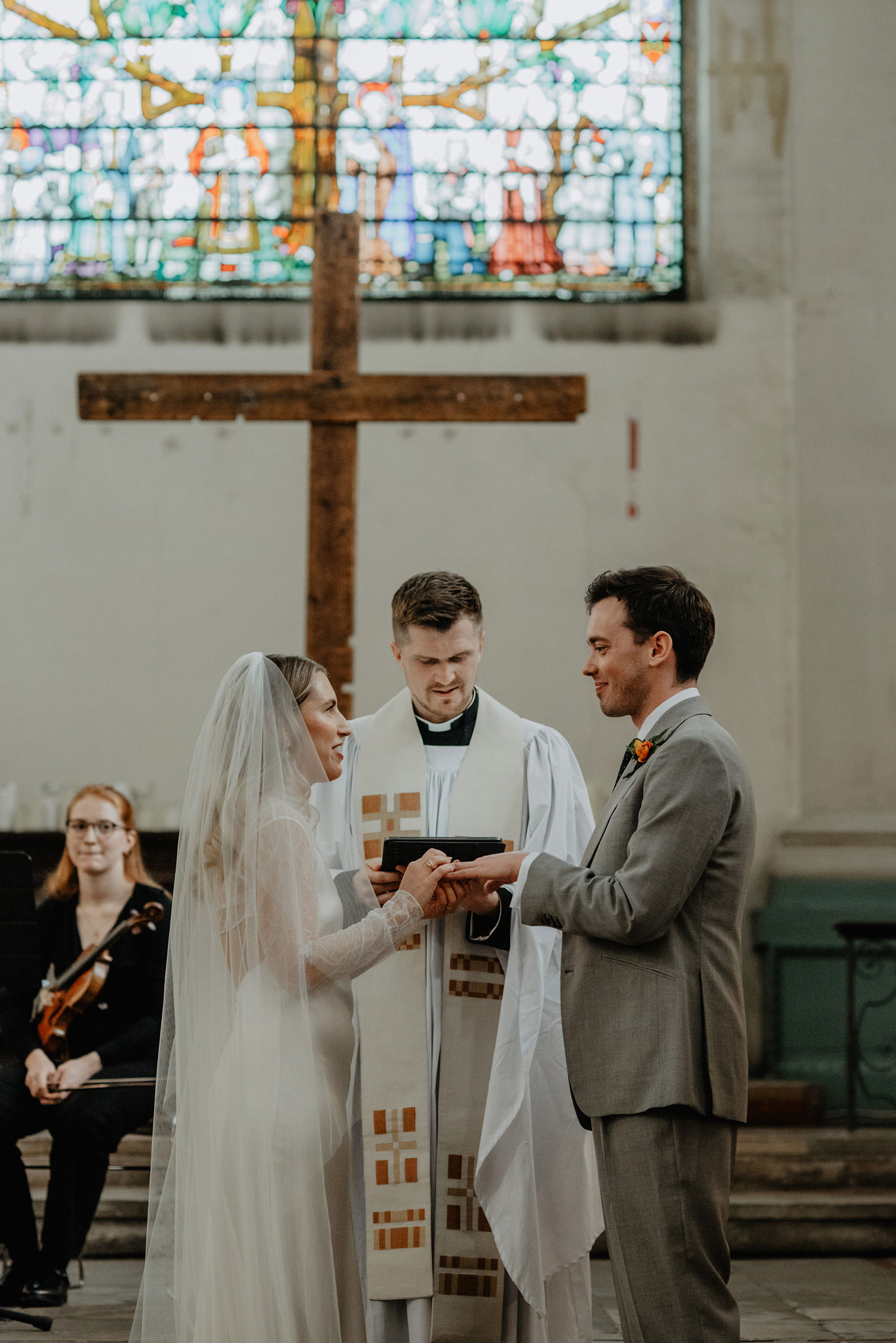 bride and groom saying vows during modern colourful wedding at shoreditch church st leonards