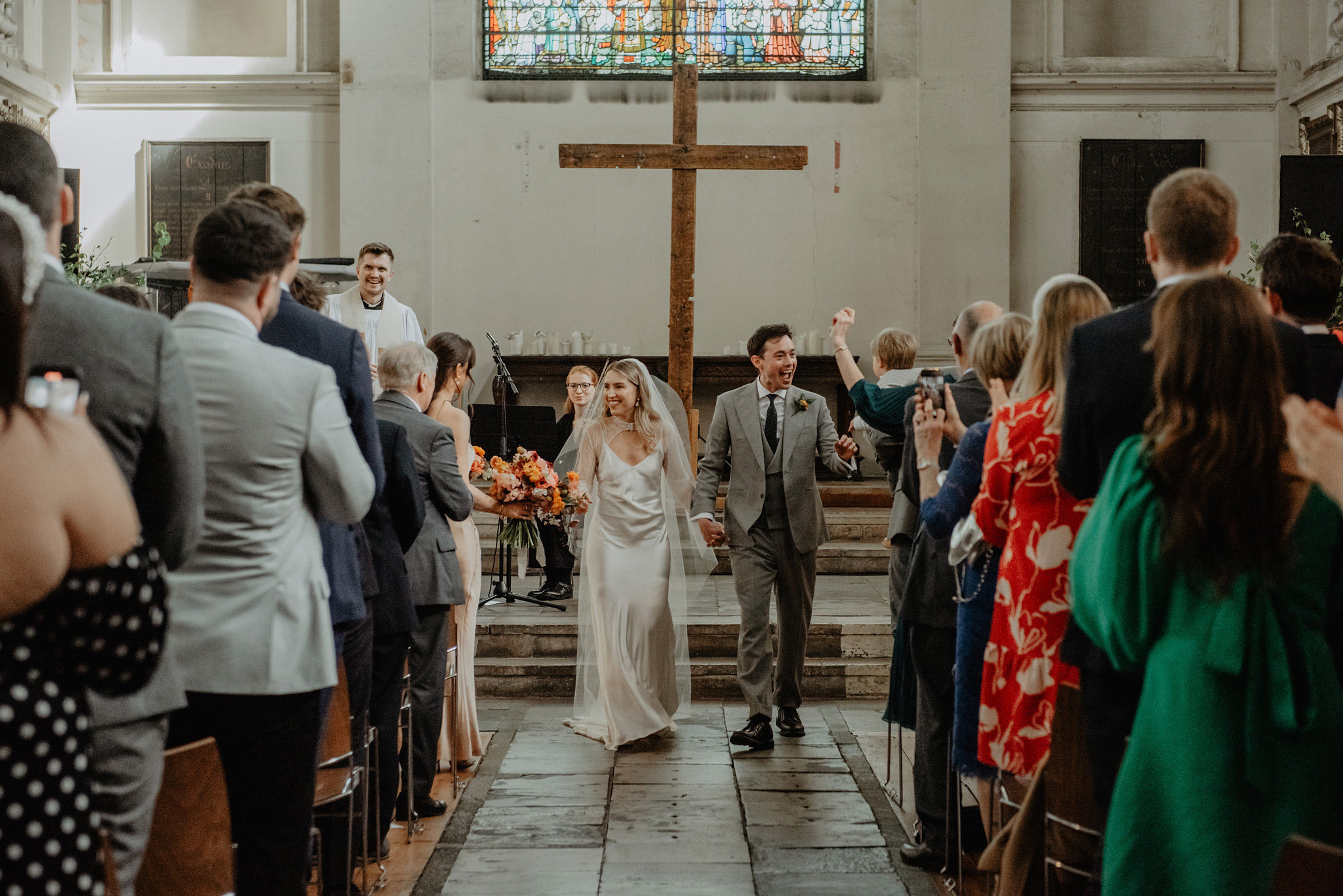 bride and groom walking aisle after wedding service at shoreditch church