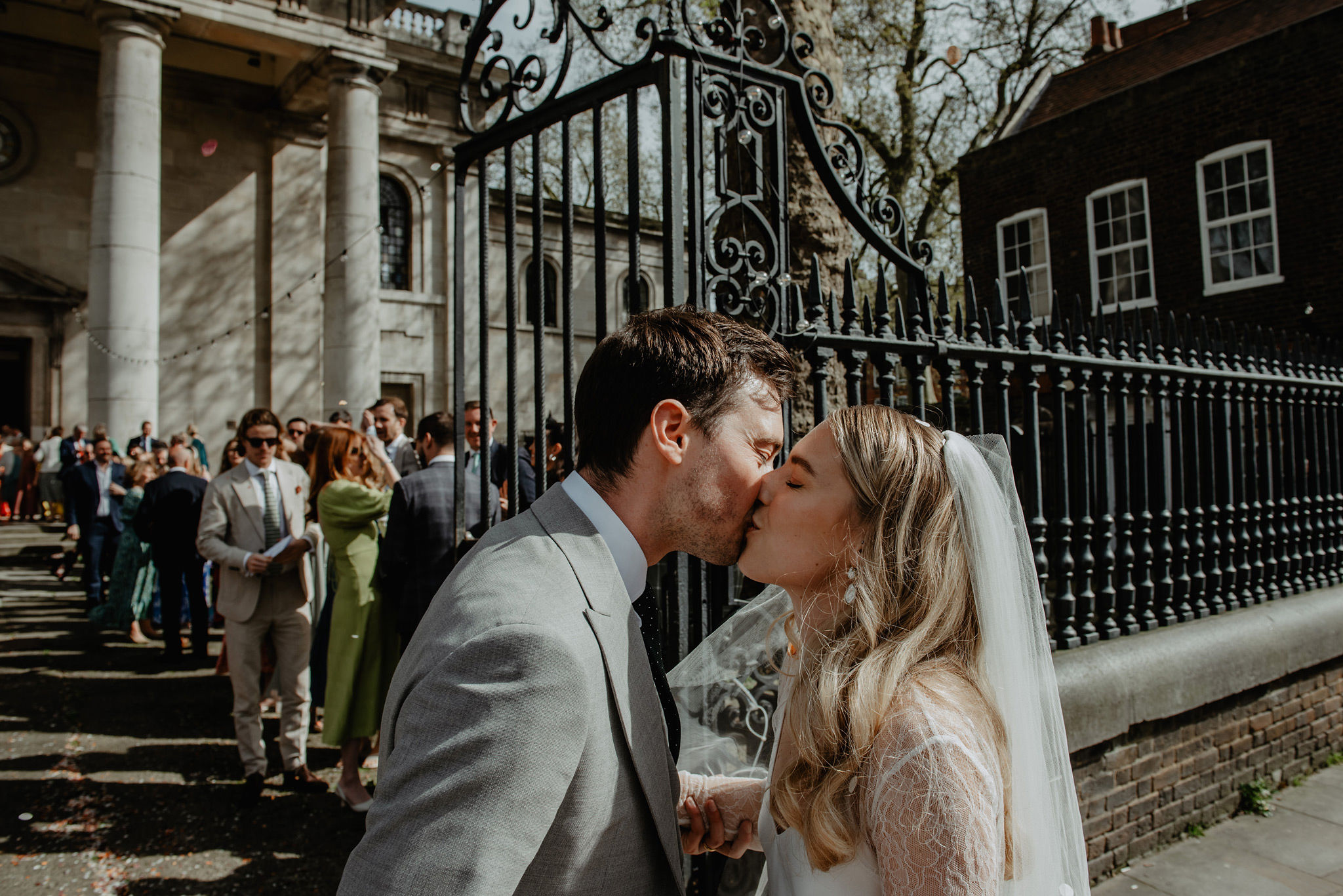 bride and groom kiss outside church in hackney by anne schwarz wedding photography