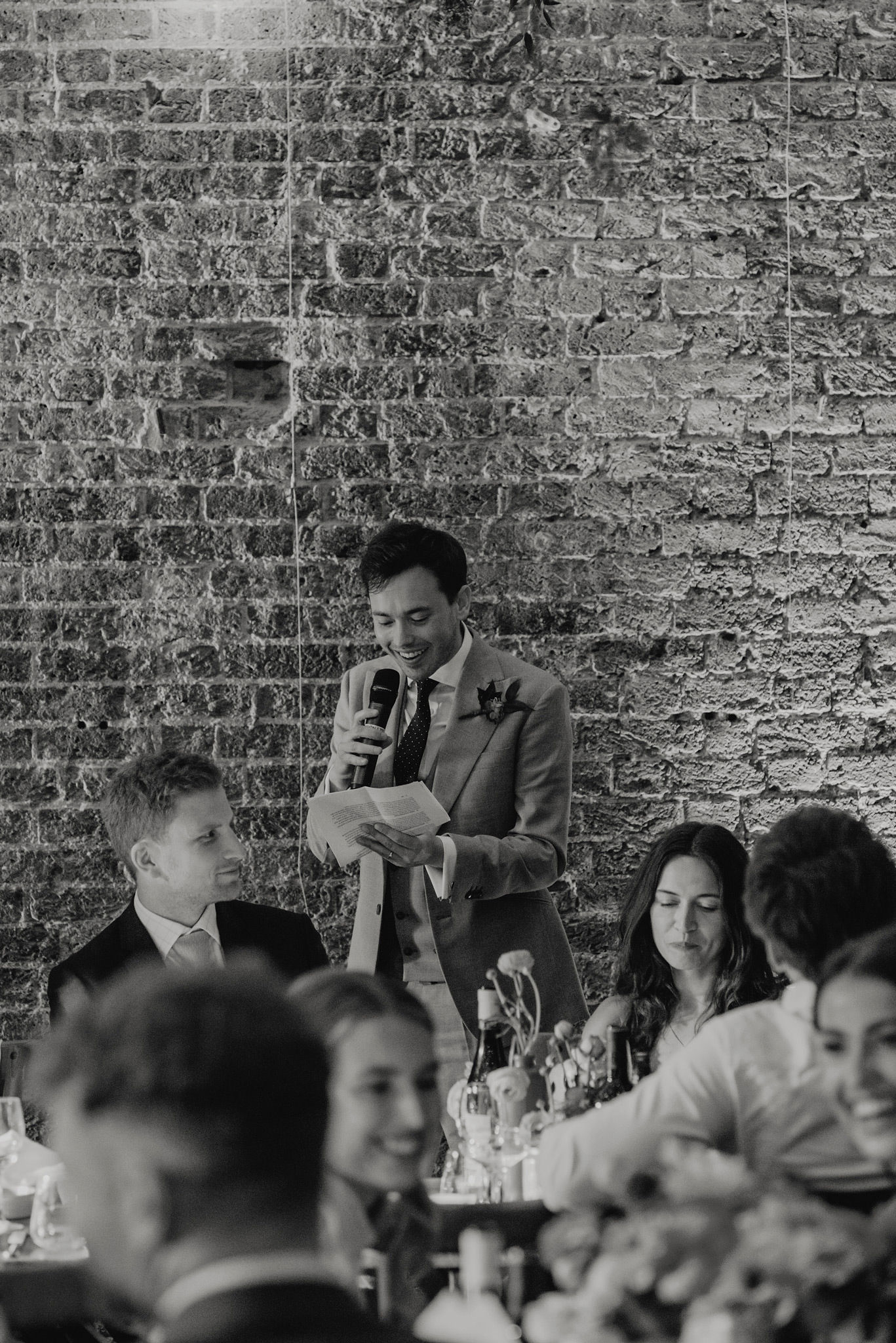 black and white photo of groom giving speech at shoreditch studios wedding