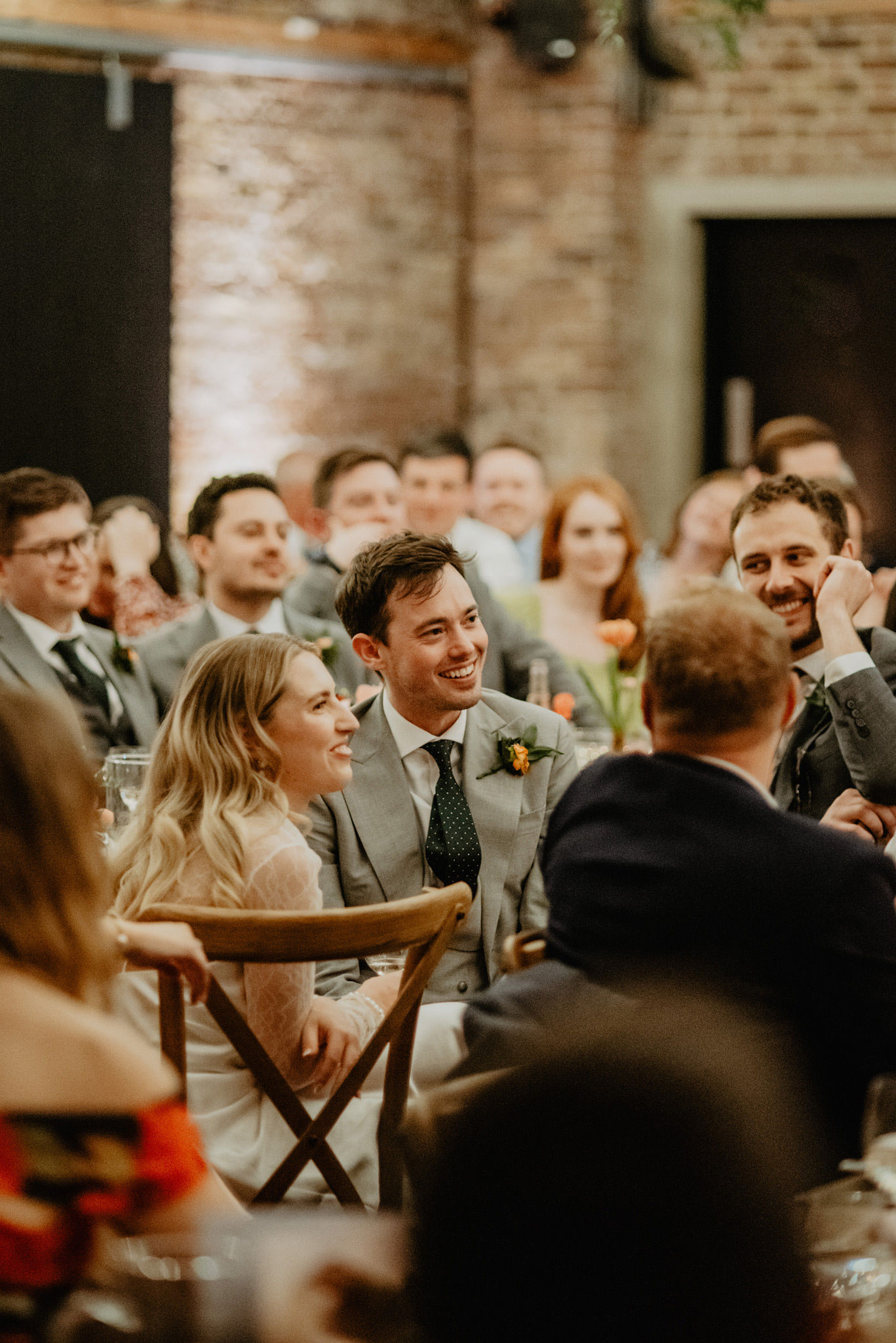 bride groom listening to best man speech at shoreditch studios wedding venue